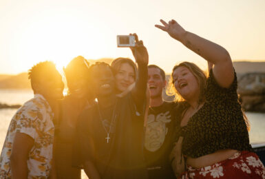 group of friends at sunset on a beach