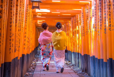 Japanese women in kimonos walking to Fushimi Inari Shrine in Japan