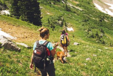 two girls hiking together in the mountains