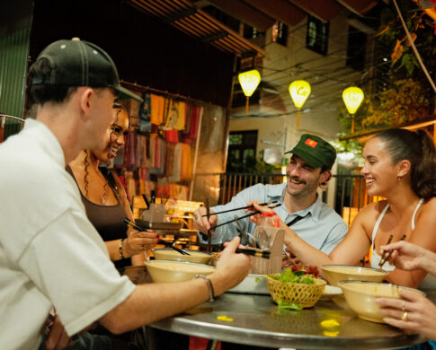 Contiki travellers in Vietnam eating food