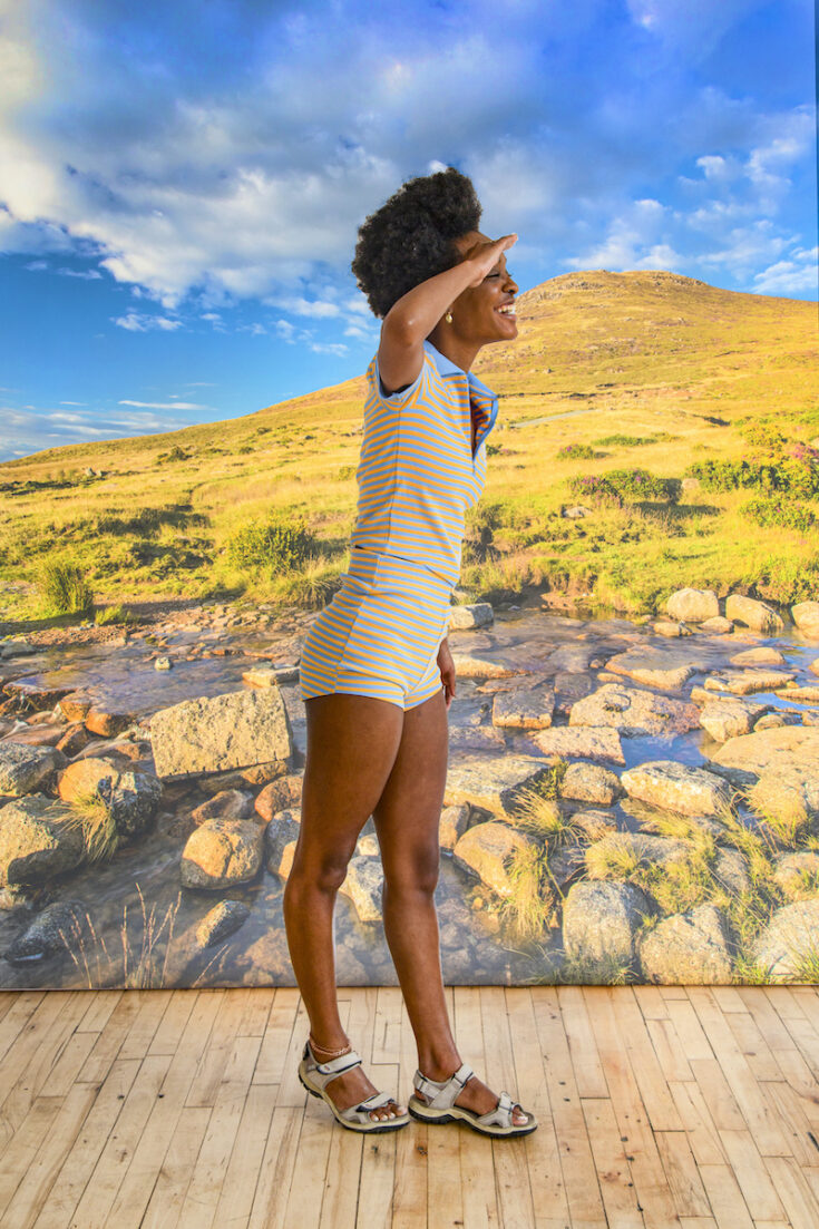 Young woman with a hill in Northern Ireland as the background.