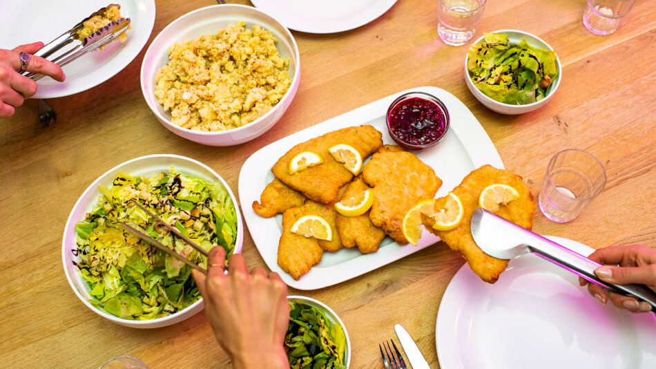 A group of people are enjoying a delicious meal together at a table.