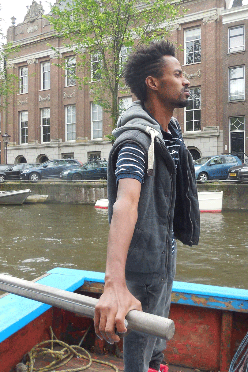 A man on a boat navigating the waters between Lampedusa and Amsterdam.