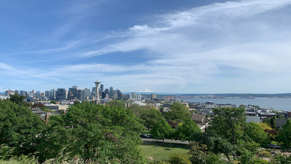 A breathtaking view of the Seattle skyline from a hill, reminiscent of iconic Grey's Anatomy destinations.
