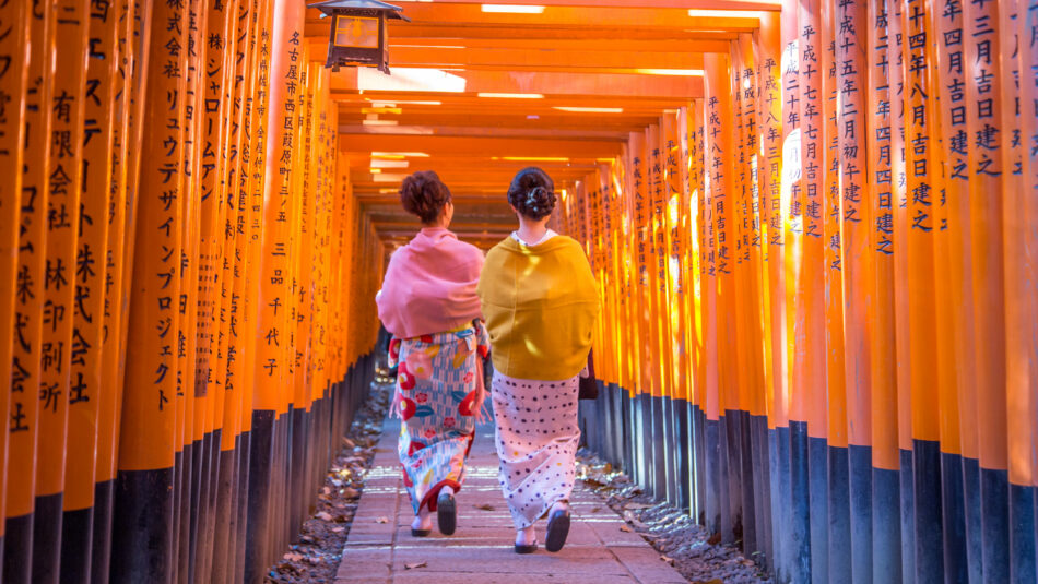 Japanese women in kimonos walking to Fushimi Inari Shrine in Japan
