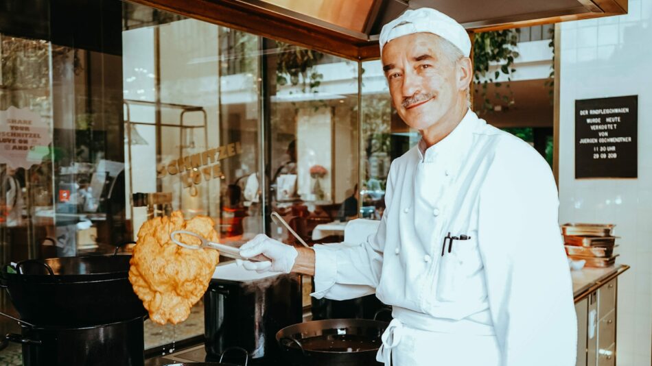 Austrian chef holding Austrian Schnitzel