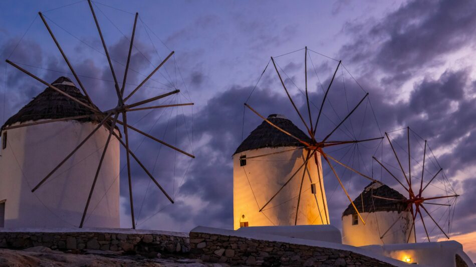 Travel bucket list: Windmills at dusk in Mykonos, Greece.