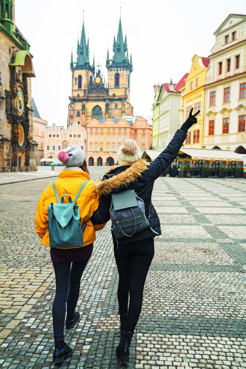 Two girls in a square with their arms around each other