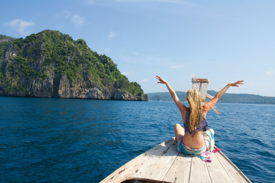 A woman exploring affordable countries on a boat.