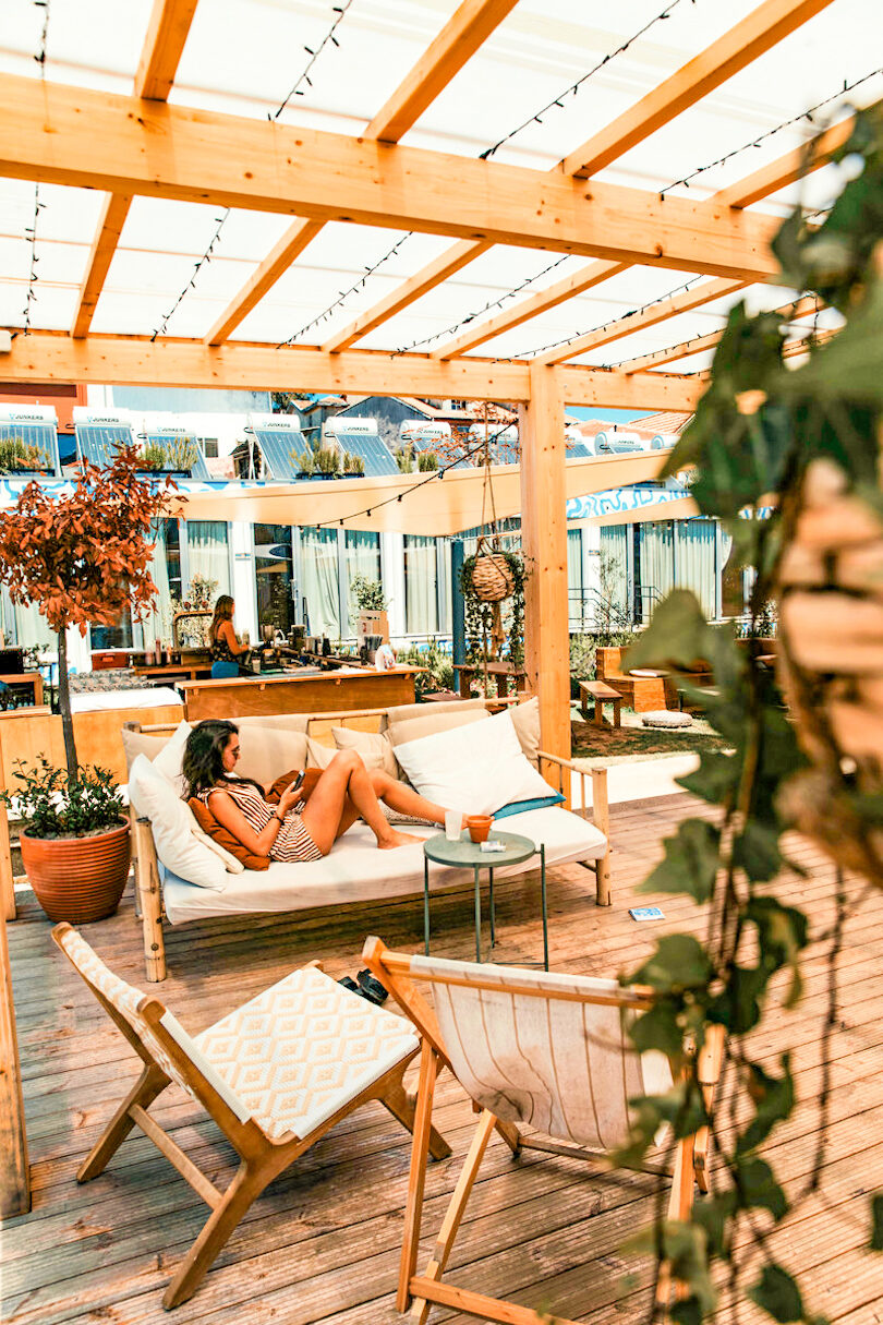 Woman lying in chair in Selina Hostels, Portugal