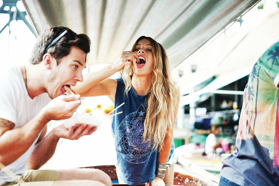 A couple enjoying food on a boat.