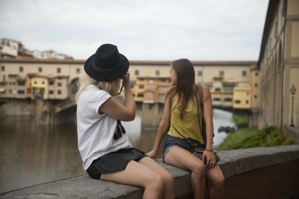 girls looking over the river in florence