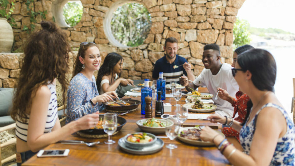 A group of people eating at a restaurant in Ibiza.