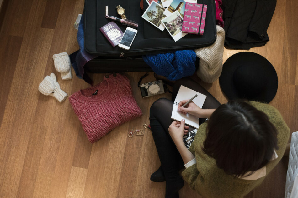 Girl writing with luggage