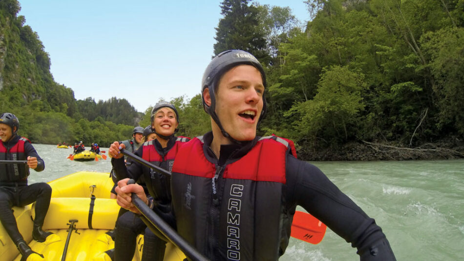 A group of people spending money while rafting down a river.