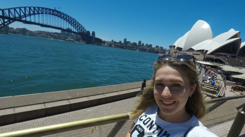 A Contiki trip manager captures a woman's selfie at the Sydney Opera House in Australia.