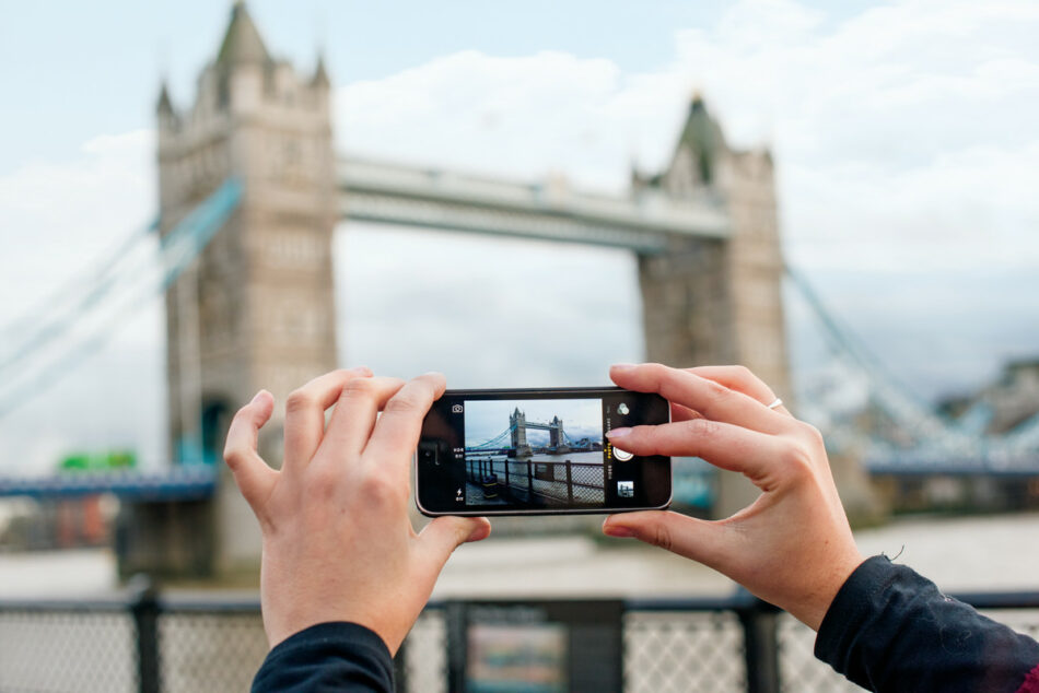 A person travelling to Europe for the first time takes a picture of Tower Bridge in London.