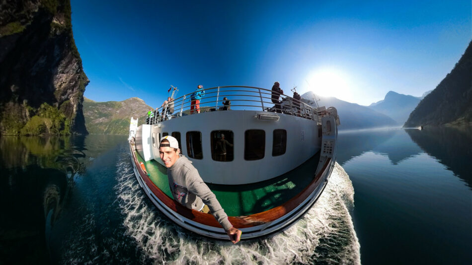 A person is enjoying a boat ride on a serene lake during their trip to Scandinavia.