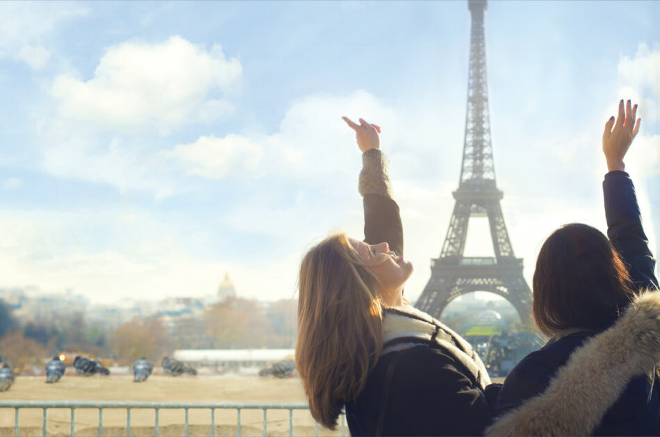 Two women from the #contikigirlsquad standing in front of the Eiffel Tower.