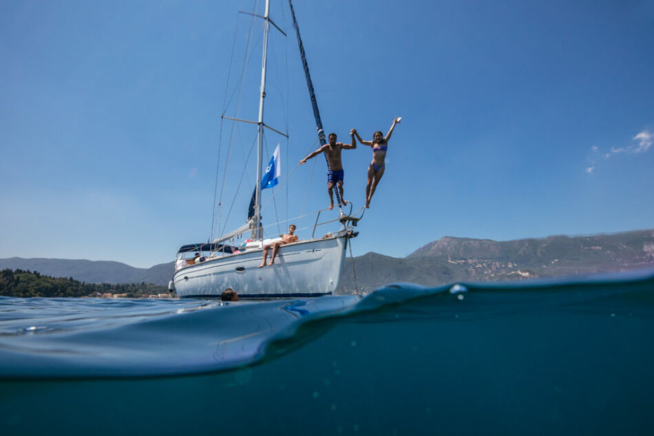 Two people boosting their career by jumping off of a sailboat.