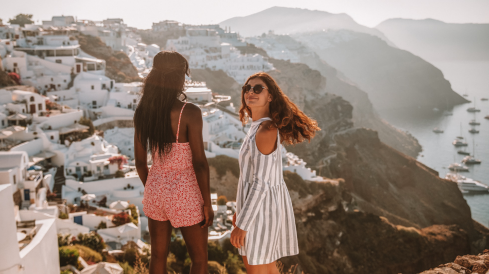 Two girls overlooking Greece scene