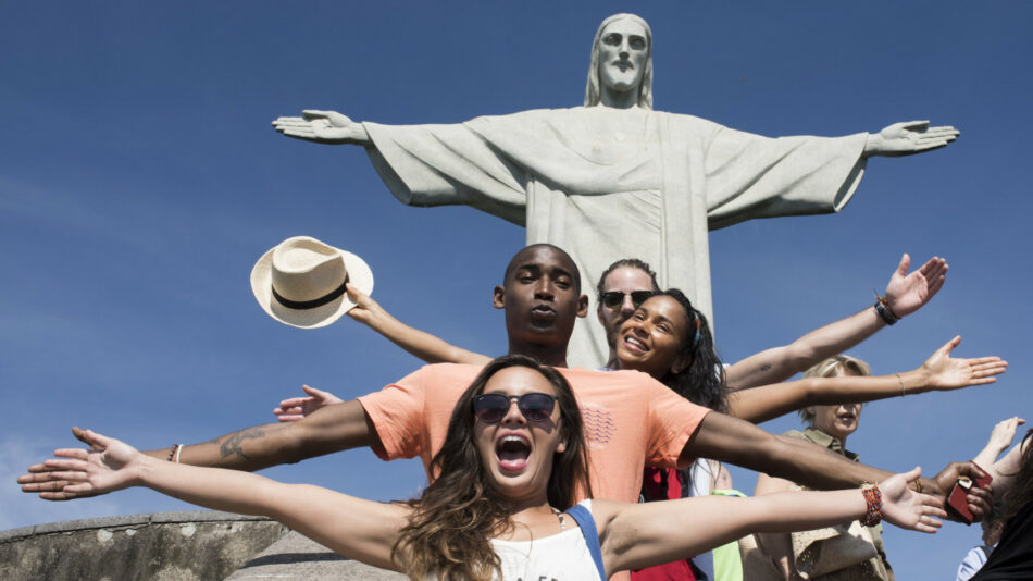 things to do in Latin America before you die - people posing with Christ the Redeemer