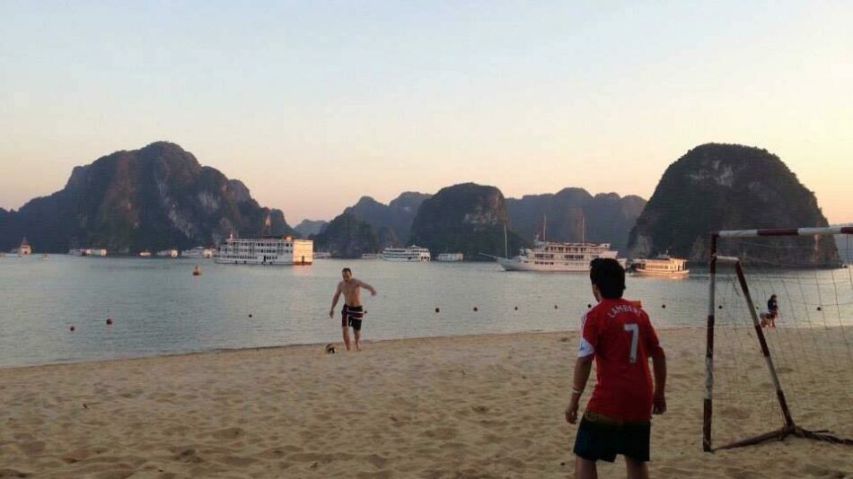 boys playing football on beach in Vietnam