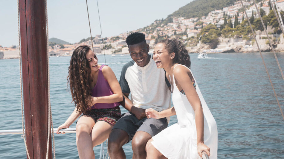 Group of friends laughing on a boat in Dubrovnik, Croatia