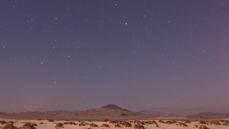 A starry sky over a desert.