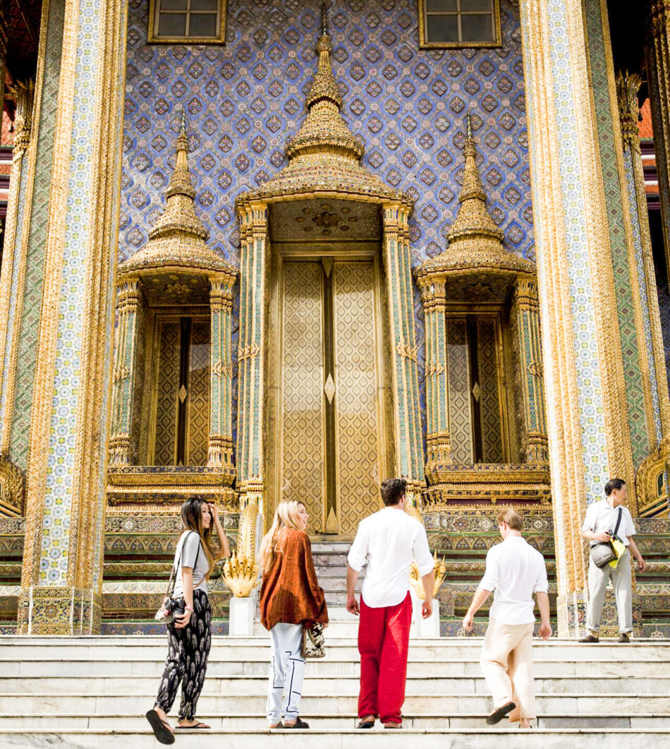 A group of Thailand digital nomads standing outside of a building.