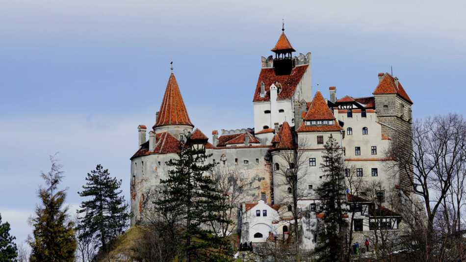 A large castle sits on top of a hill.