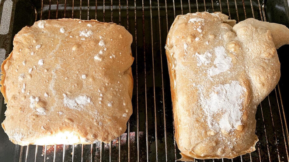 Two pieces of bread on a baking rack.