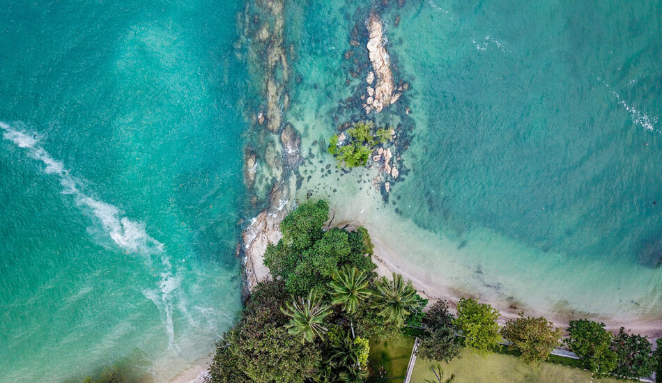 An aerial view of a beach and ocean in Thailand.