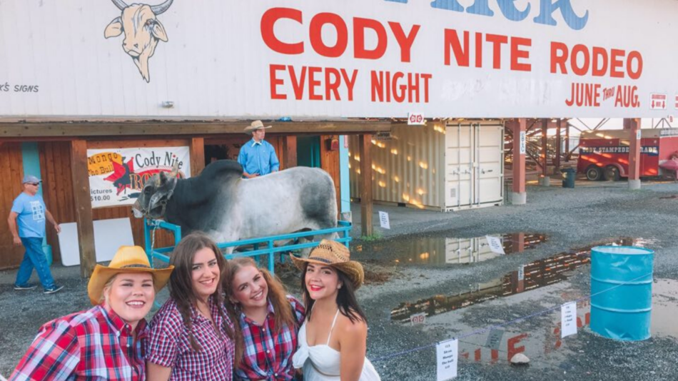 Four girls outside a rodeo venue in Cody, Wyoming