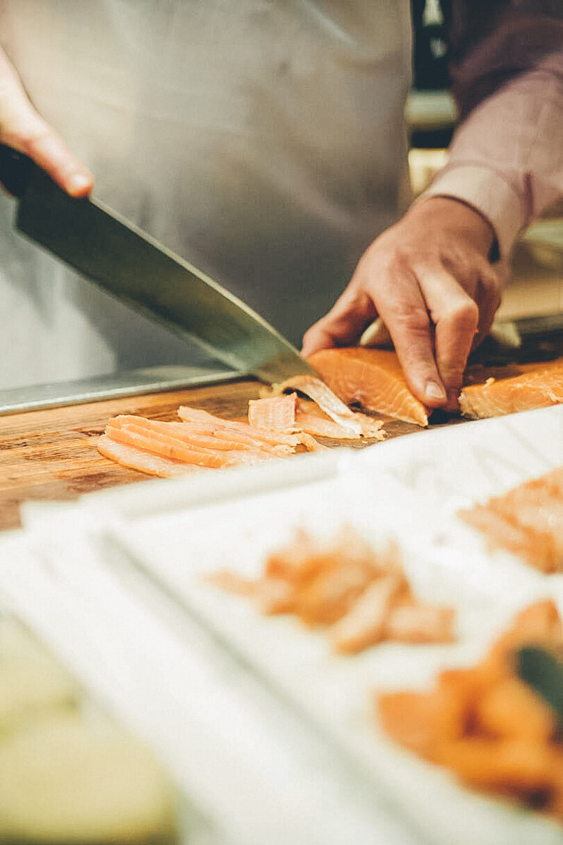 Chef slicing smoked fish