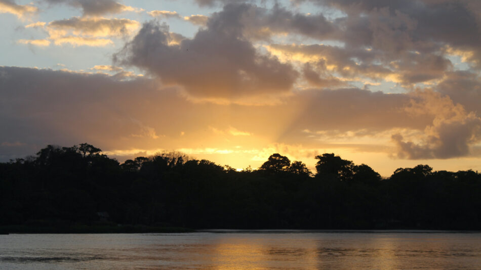 Costa Rica sunset on water and trees