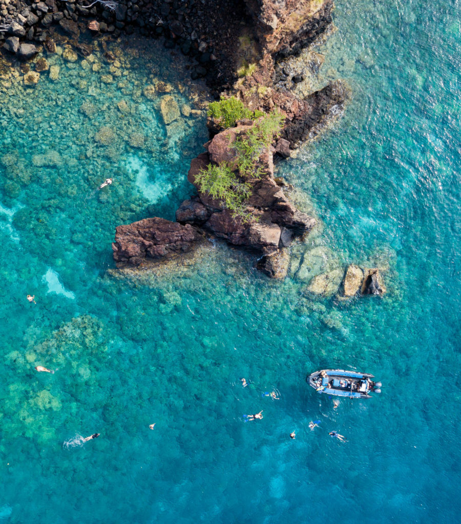 A boat is floating in the waters of Hawaii.