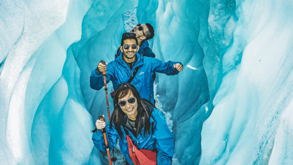 A group of people hiking through an ice cave.