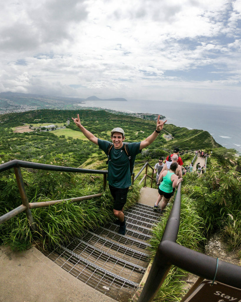 A man is standing on a stairway in Hawaii.