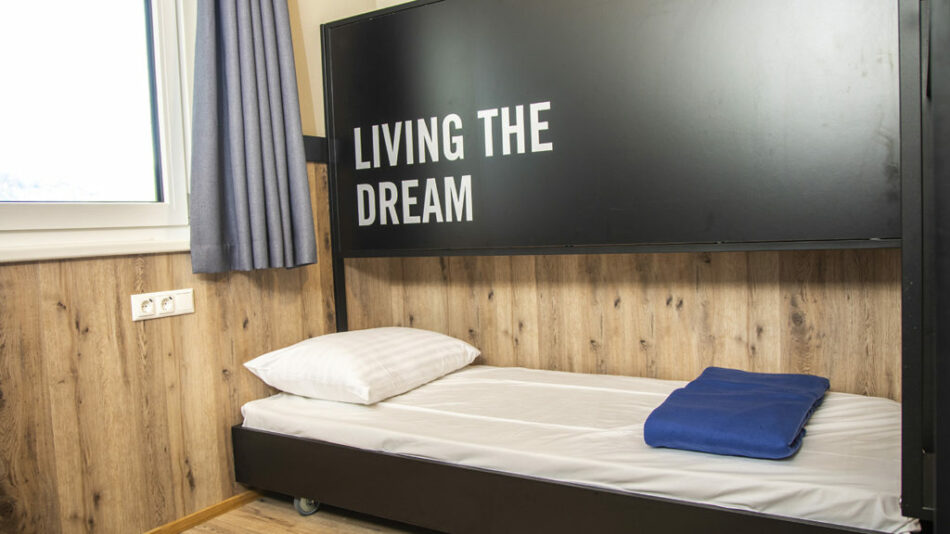 A bunk bed at Gasthof Schoneck with the words living the dream on it.