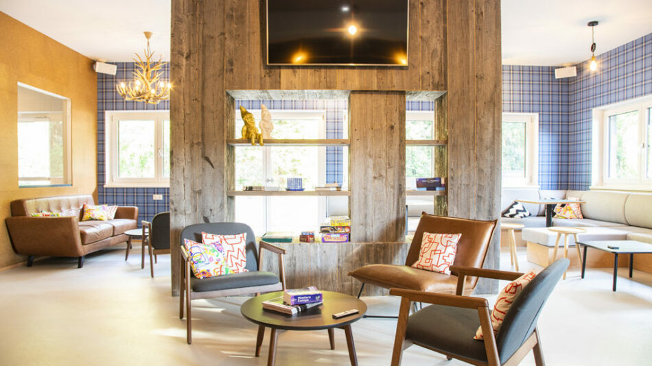 A living room with couches, chairs, and a tv at Gasthof Schoneck.