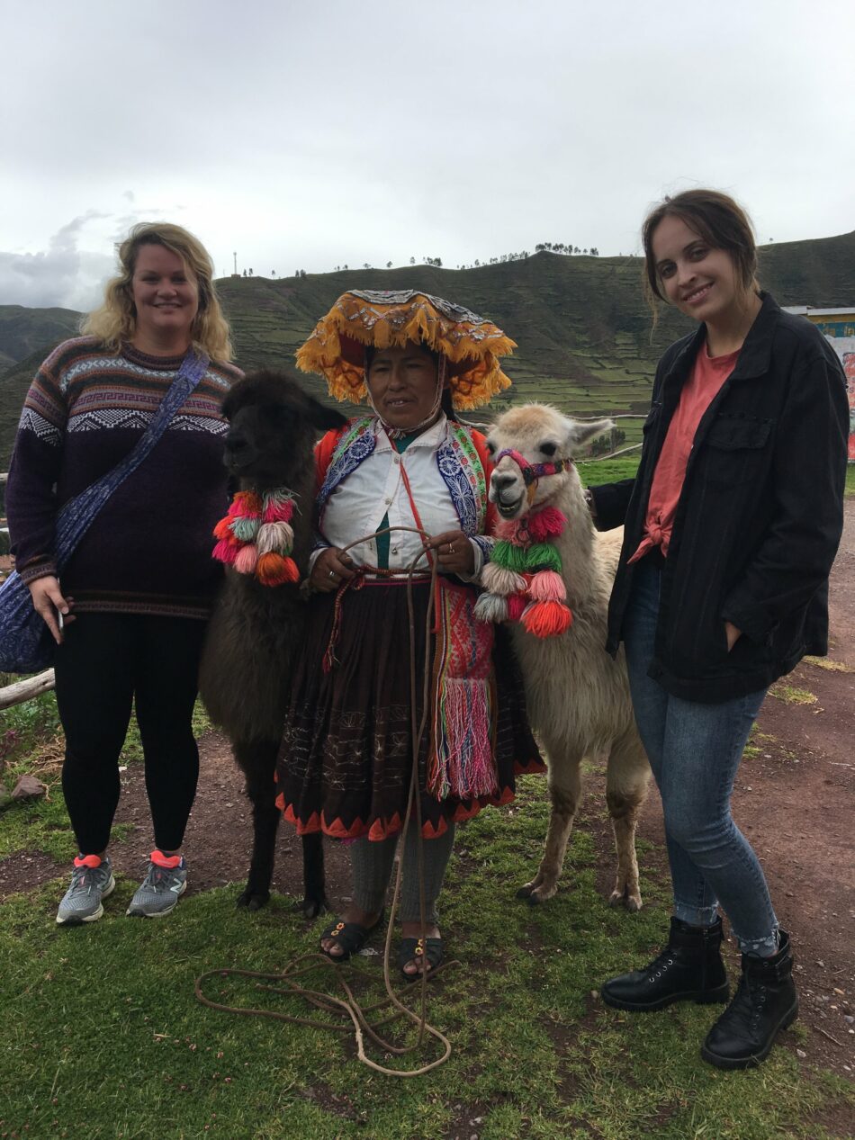 Three women hiking with llamas on the Inca Trail.