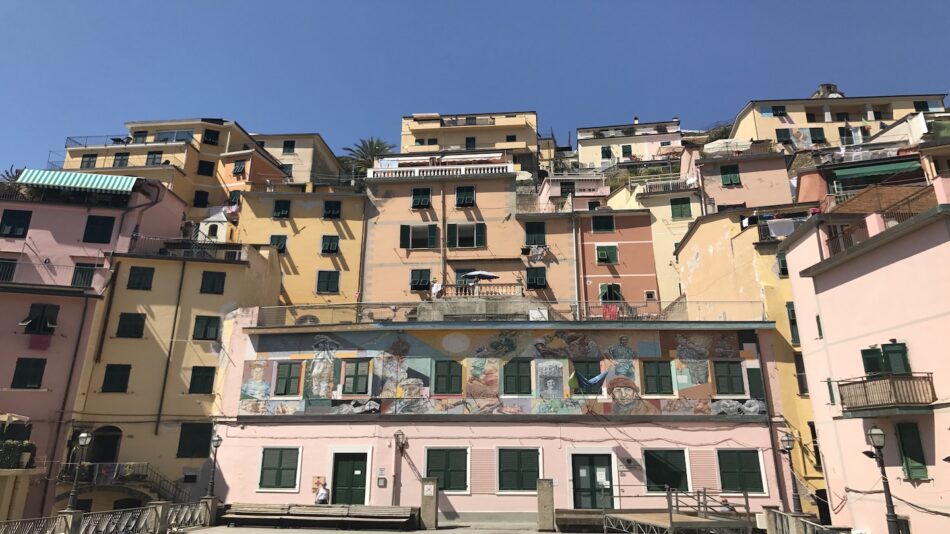 A row of colorful buildings on the side of a hill.