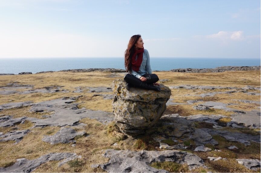 Girl-sitting-on-rocks