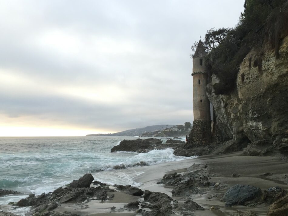         A picturesque lighthouse stands proudly on a rugged cliff, offering sweeping views of the vast ocean.