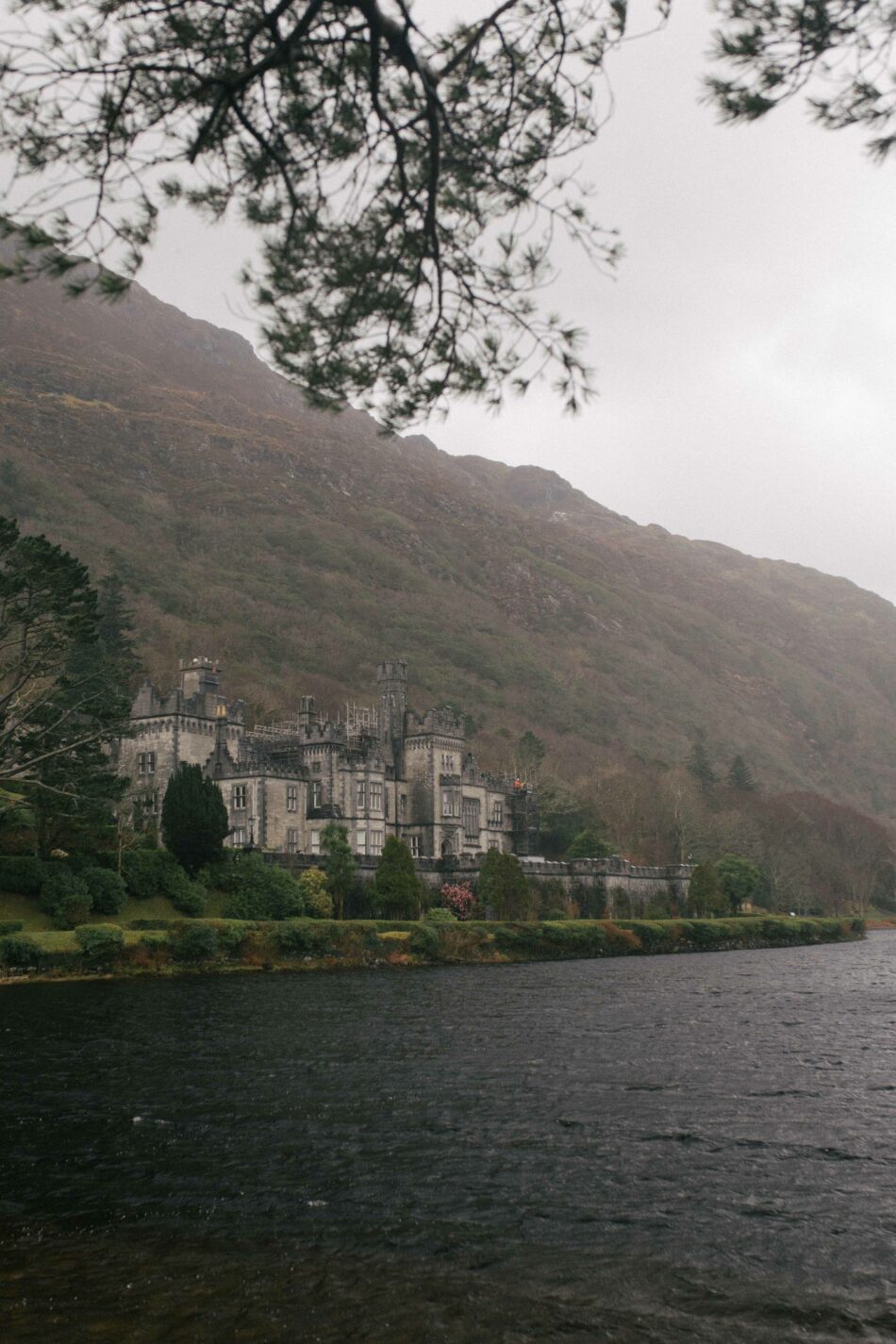 A castle with Irish roots sits on the side of a lake.