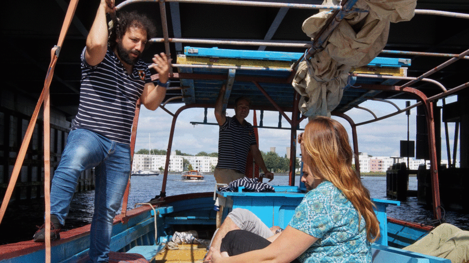 Two people, a man and a woman, embark on a boat journey from Lampedusa to Amsterdam.