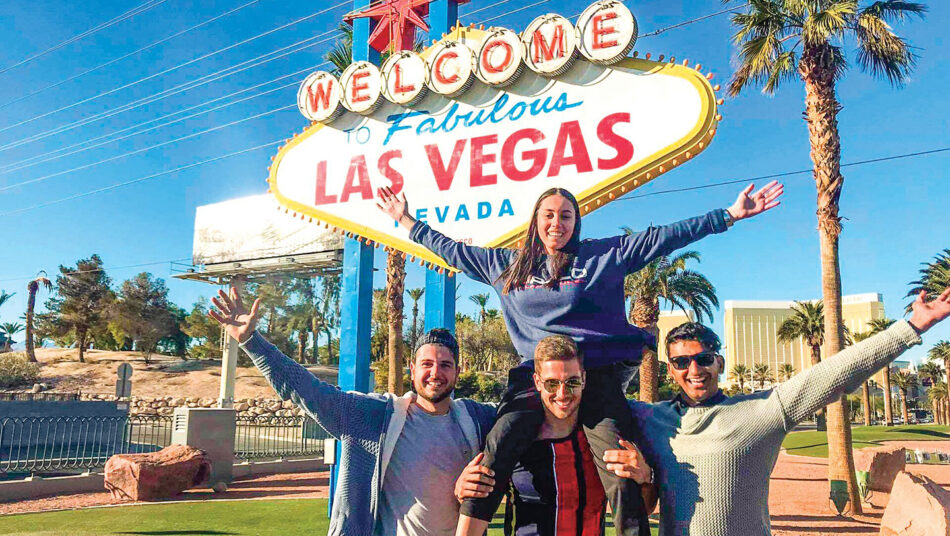 Group of travellers in front of Las Vegas sign