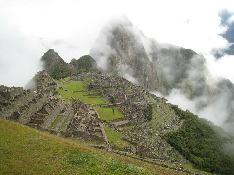 The majestic ruins of Machu Picchu shrouded in clouds.