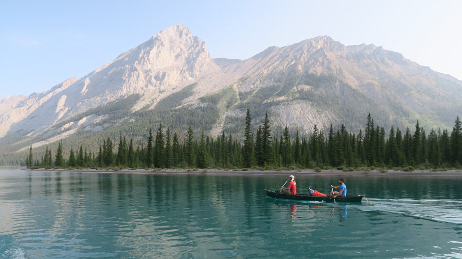 Two people in a canoe on a lake.